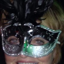 Ginny Racette with masquerade mask smiling