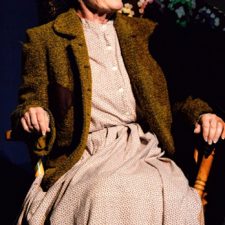 Ginny Racette sitting in a rocking chair acting in On Golden Pond
